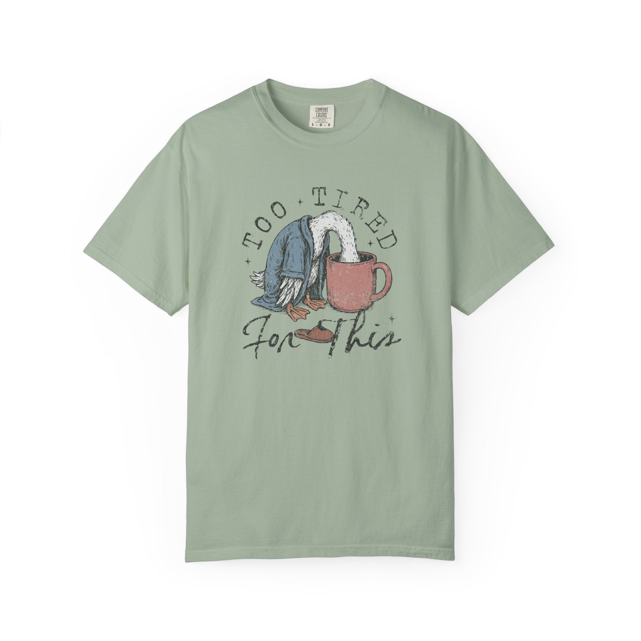 Sage green unisex t-shirt with a graphic of a duck with its head in a coffee mug.