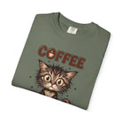 Olive green unisex cotton t-shirt featuring a graphic of a wide-eyed kitten and the word COFFEE.