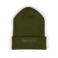 A dark green cuffed beanie with "Brevity Brew" embroidered in brown and blue.