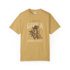 Mustard yellow t-shirt with a distressed graphic of a cowboy rat riding a donkey, drinking coffee.