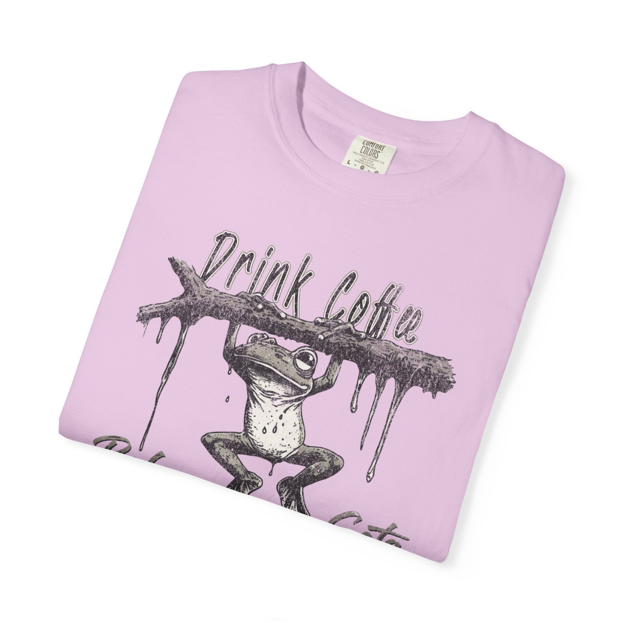 Light pink unisex t-shirt featuring a distressed graphic of a frog hanging from a branch.