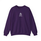 A dark purple crewneck sweatshirt featuring a small white graphic of a smiling coffee cup.