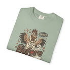 Sage green unisex t-shirt featuring a distressed graphic of a rooster wearing a Rise and Shine apron.