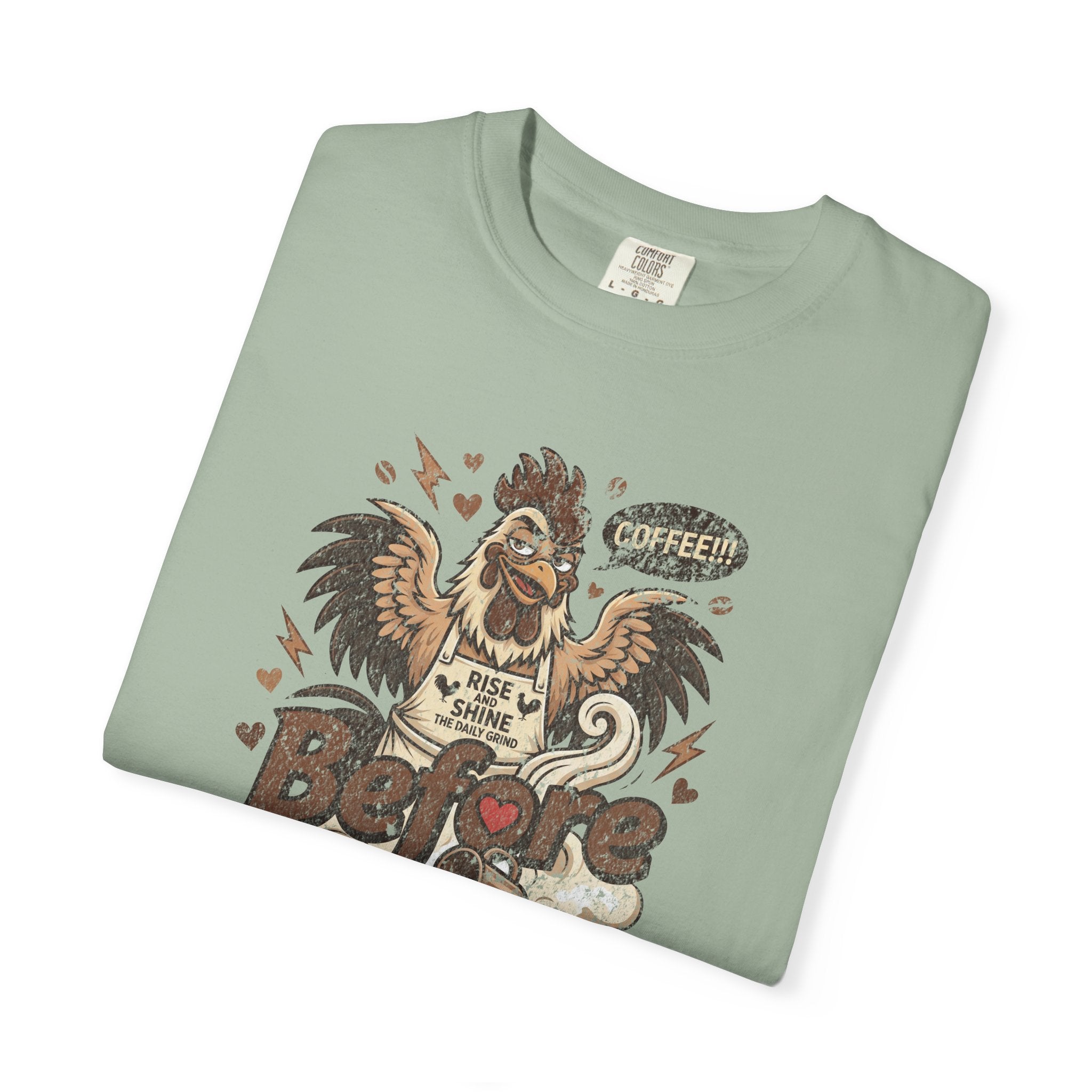 Sage green unisex t-shirt featuring a distressed graphic of a rooster wearing a Rise and Shine apron.