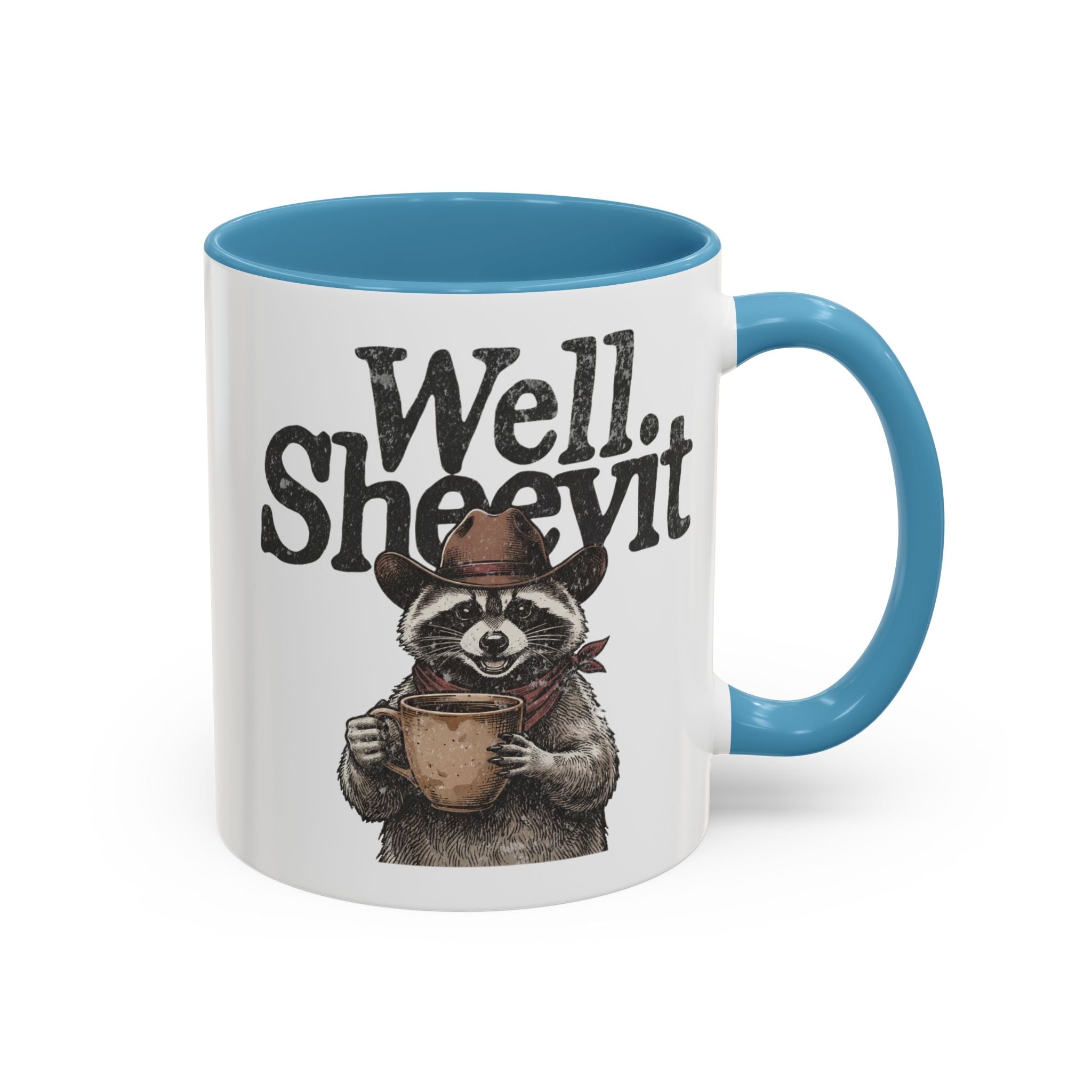 White ceramic mug with a blue handle and rim, featuring a raccoon wearing a cowboy hat and scarf.