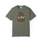 An olive green t-shirt featuring a retro distressed graphic that says Be Like Coffee.