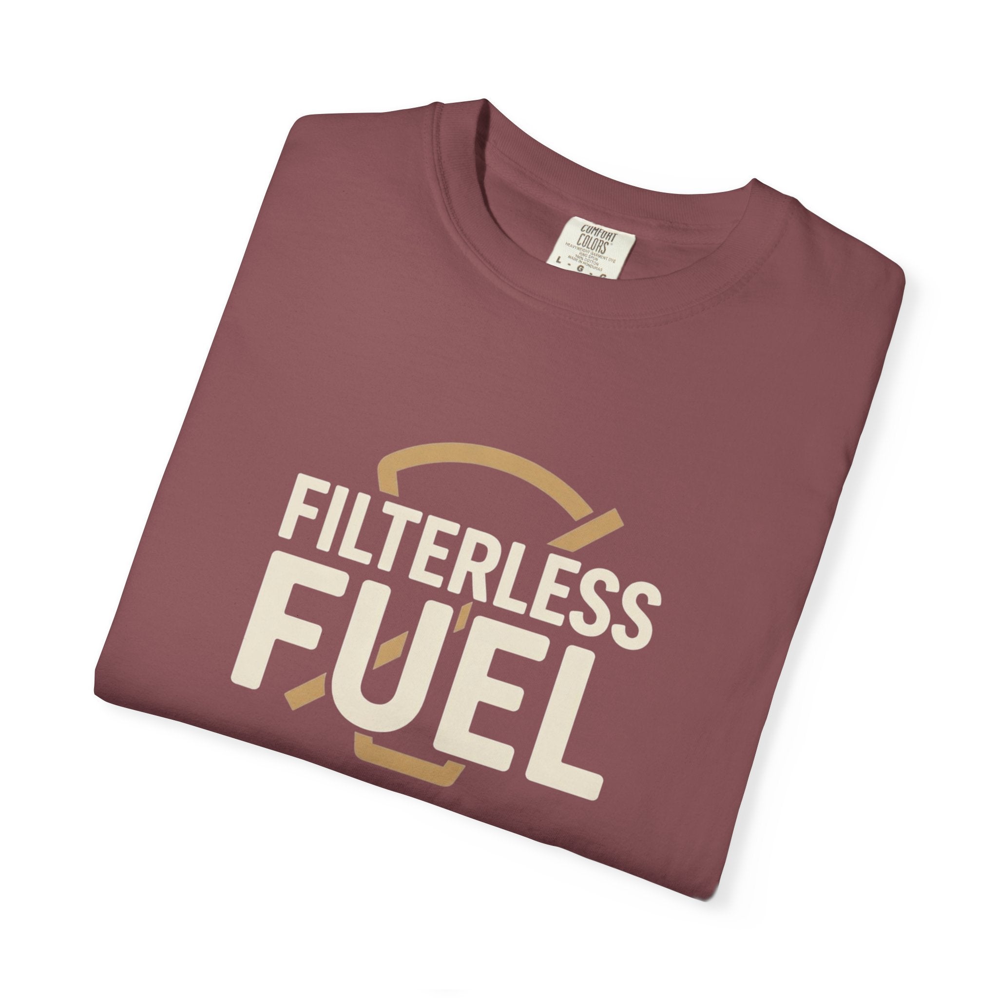 A folded maroon unisex t-shirt featuring the text Filterless Fuel in a retro cream font.
