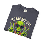 Dark grey t-shirt featuring a green alien wearing sunglasses and making peace signs with coffee.