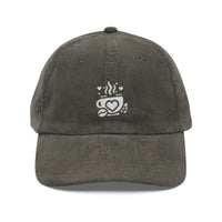 Dark grey corduroy baseball cap with an embroidered white coffee cup and heart logo.