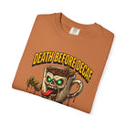 Orange unisex cotton t-shirt featuring a graphic of a zombie coffee mug with glowing green eyes.