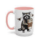 White ceramic mug with a pink handle and interior, featuring a raccoon holding a coffee cup.