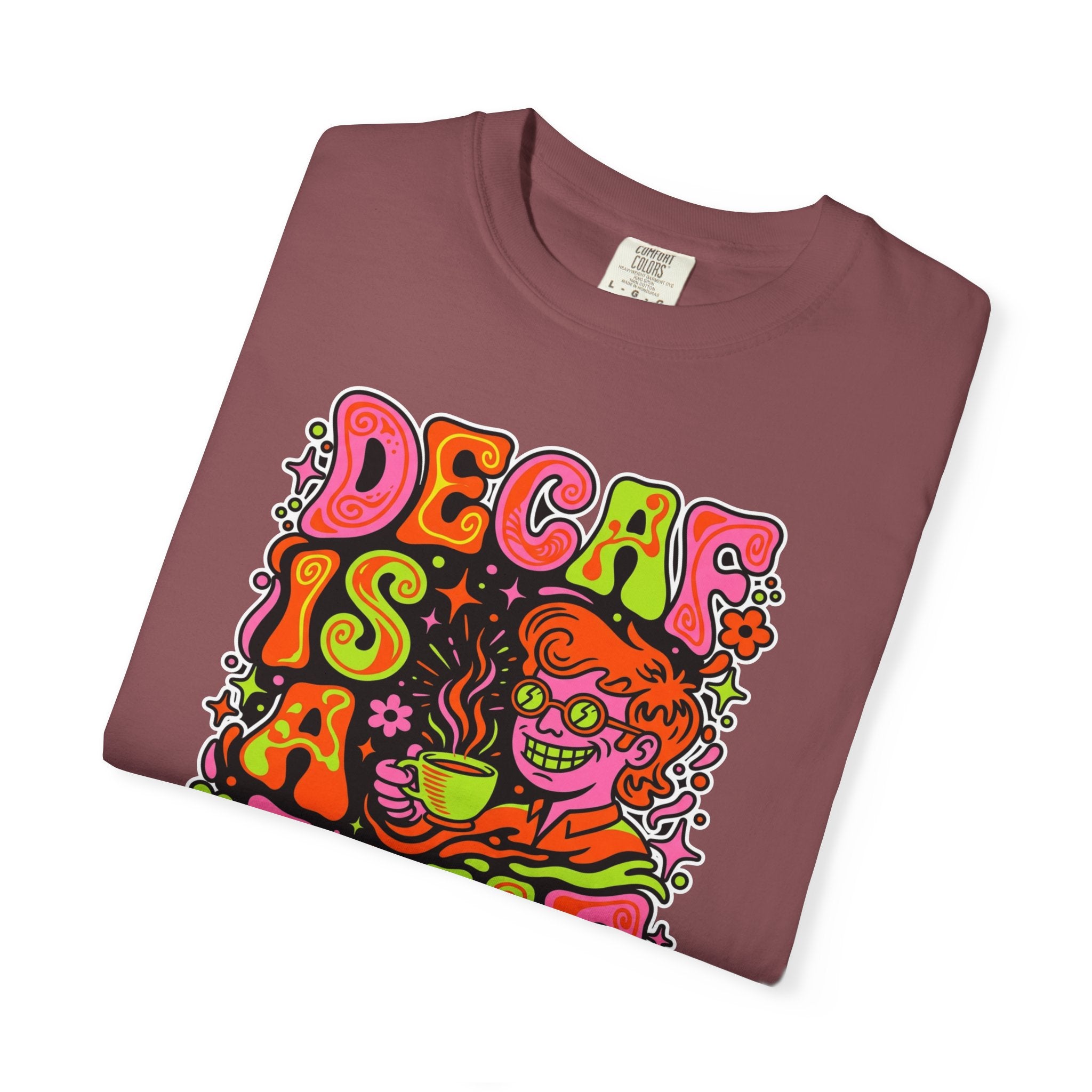 Folded maroon t-shirt with a retro psychedelic graphic of a person drinking coffee.
