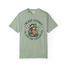 Sage green unisex t-shirt with a graphic of a raccoon wearing glasses and reading a book.