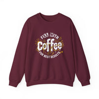 A maroon crewneck sweatshirt featuring a white and gold graphic that says Fill With Coffee.