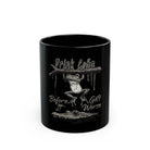 Black ceramic mug featuring a frog hanging from a branch above an alligator with text.