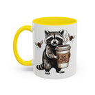 White ceramic mug with a yellow handle and interior, featuring a raccoon holding a coffee cup.