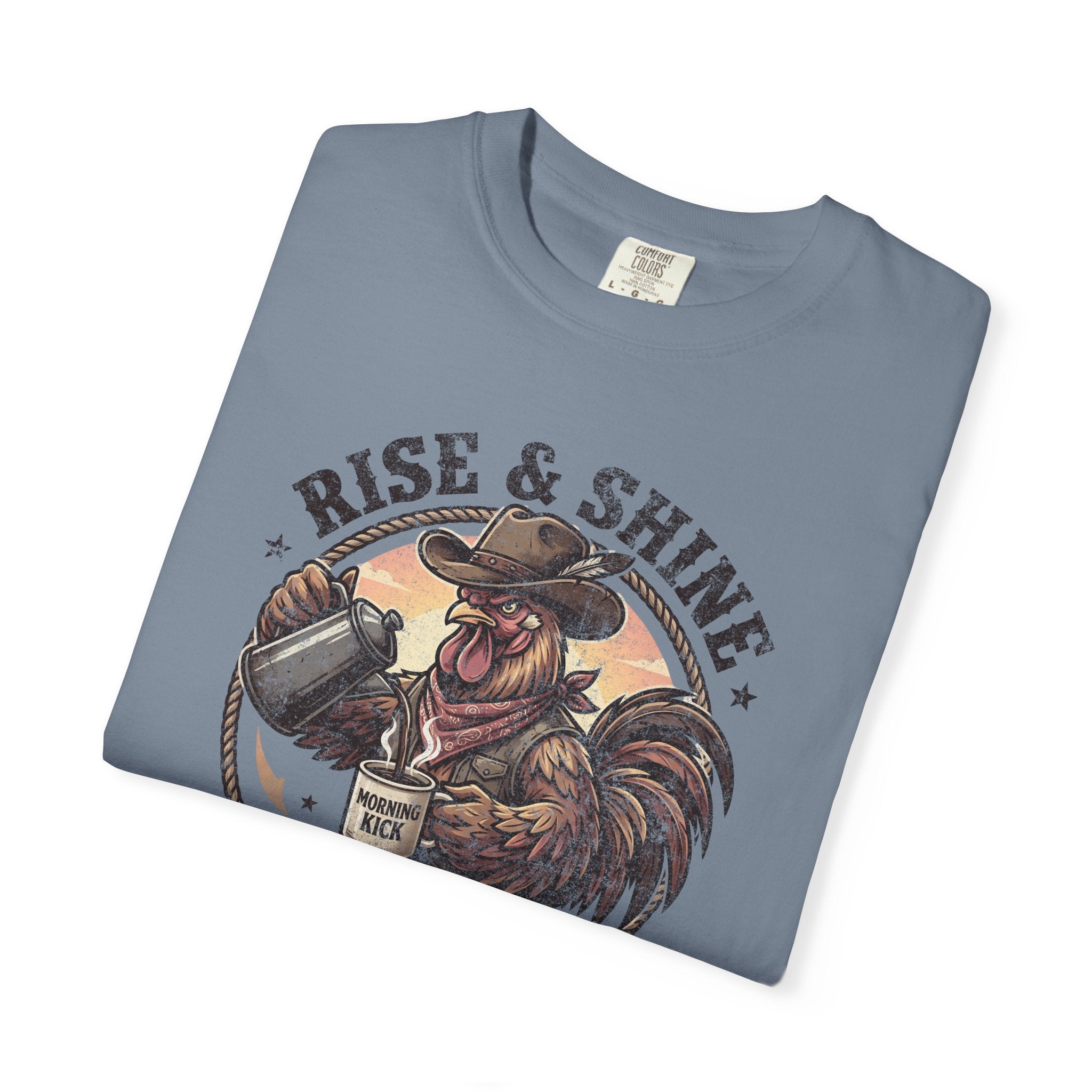 Folded blue cotton t-shirt featuring a graphic of a cowboy rooster pouring coffee.